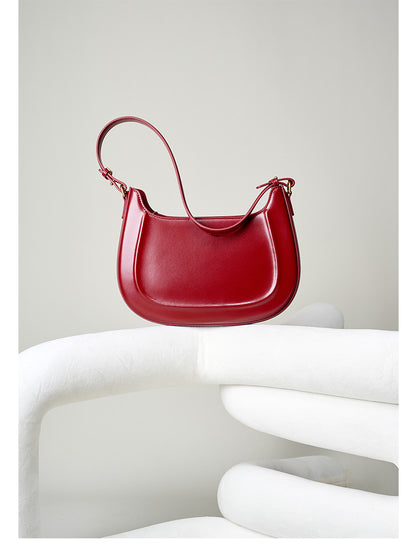 Wine red leather shoulder bag styled on display