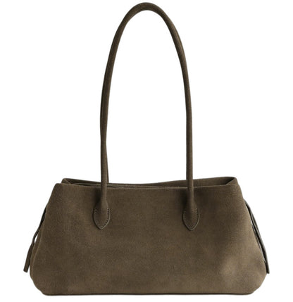 Tote shown with its long handles and wide horizontal silhouette