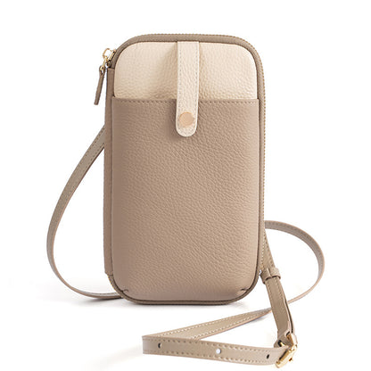 Beige and cream two-tone leather phone bag with adjustable crossbody strap on white background