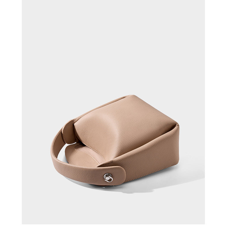 Top-down view showing magnetic snap closure on pebbled leather bag