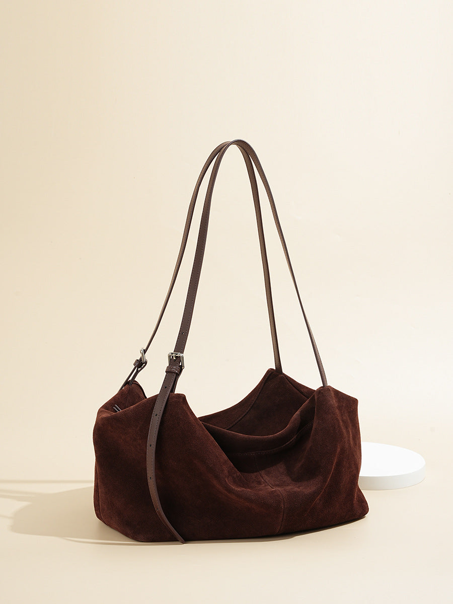 Angled view of soft-structured brown leather shoulder tote