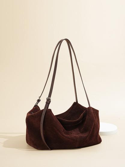 Angled view of soft-structured brown leather shoulder tote