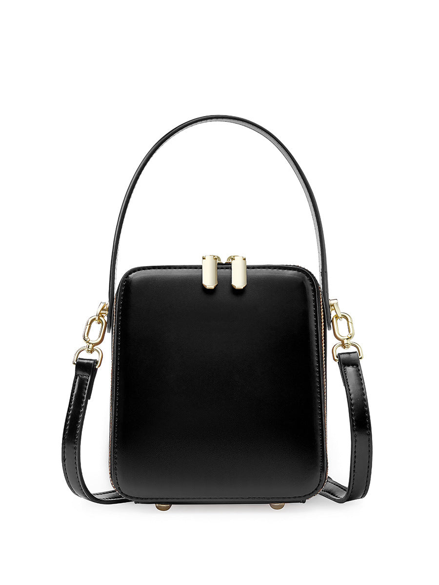 Black cowhide leather mini box bag front view with gold-tone double zip and top handle