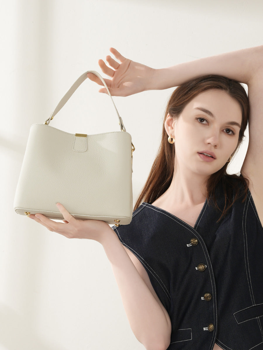 Model showcasing the top handle of the off-white bag