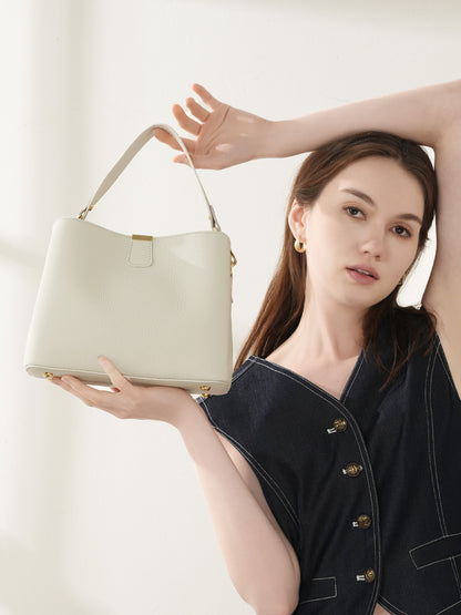 Model showcasing the top handle of the off-white bag