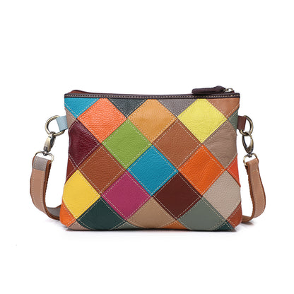 Back view showing bright geometric patchwork panels on the cowhide bag