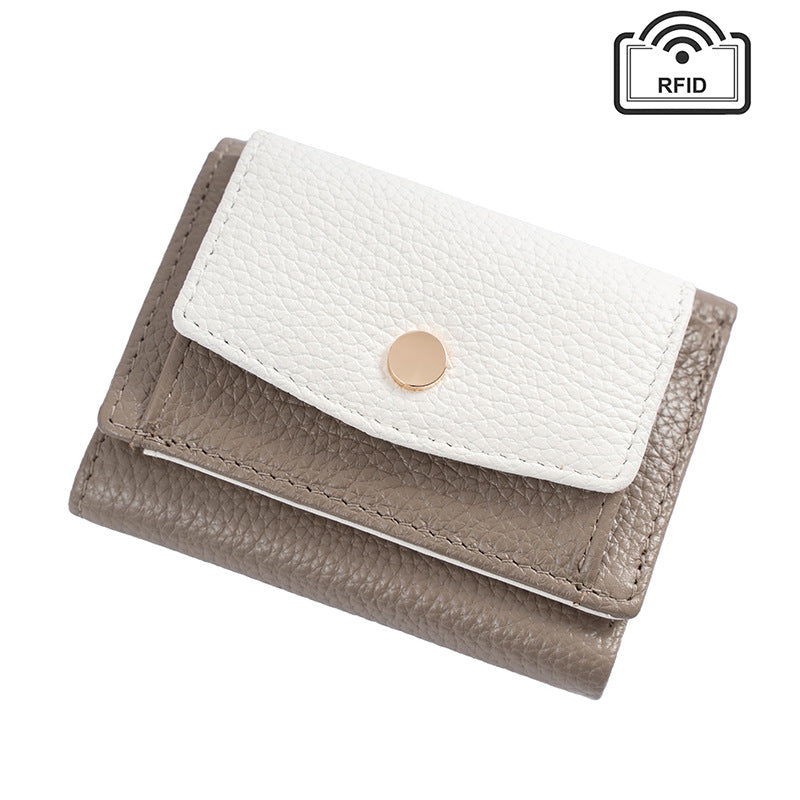 Two-tone gray and ivory leather wallet with round snap detail