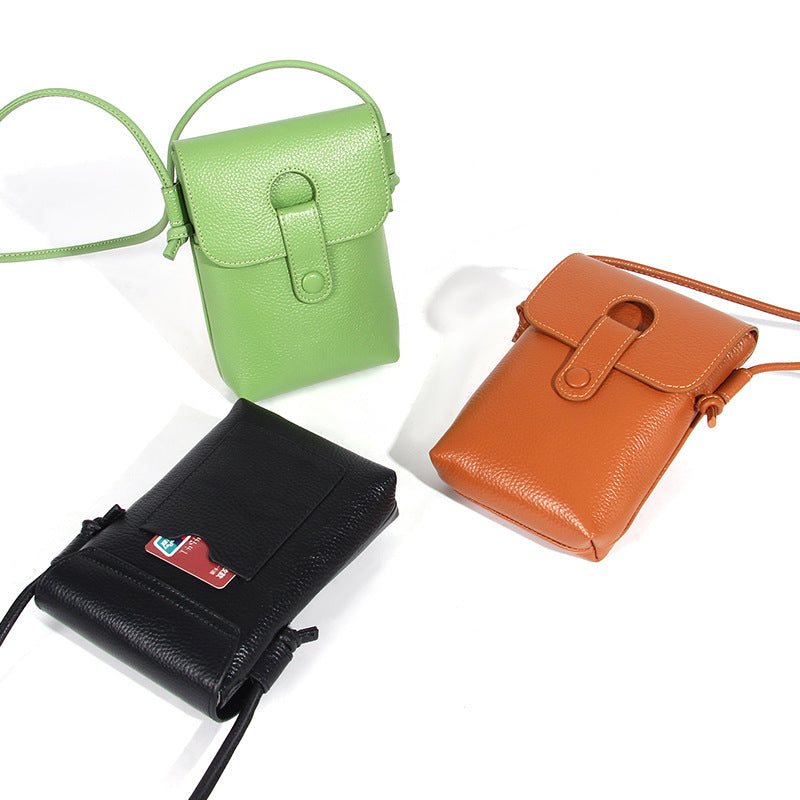 Three color variations of the pebbled leather phone bag laid flat showing back card slot