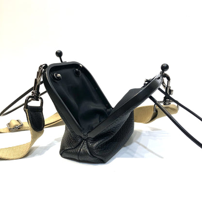 Open black bag showing frame clasp and interior