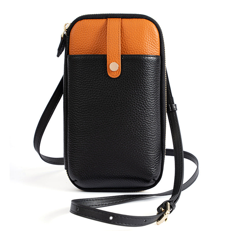 Black and orange two-tone leather phone bag with gold-tone hardware and crossbody strap