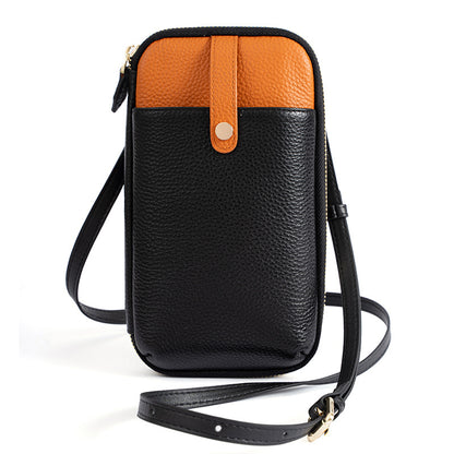 Black and orange two-tone leather phone bag with gold-tone hardware and crossbody strap