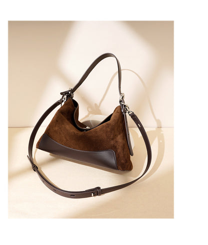Side angle highlighting the soft tote shape and leather panels