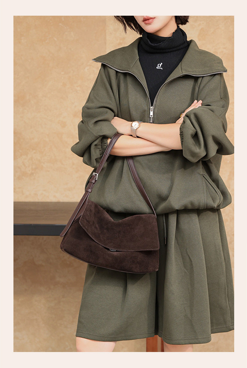 Dark brown flap shoulder bag styled with a casual outfit