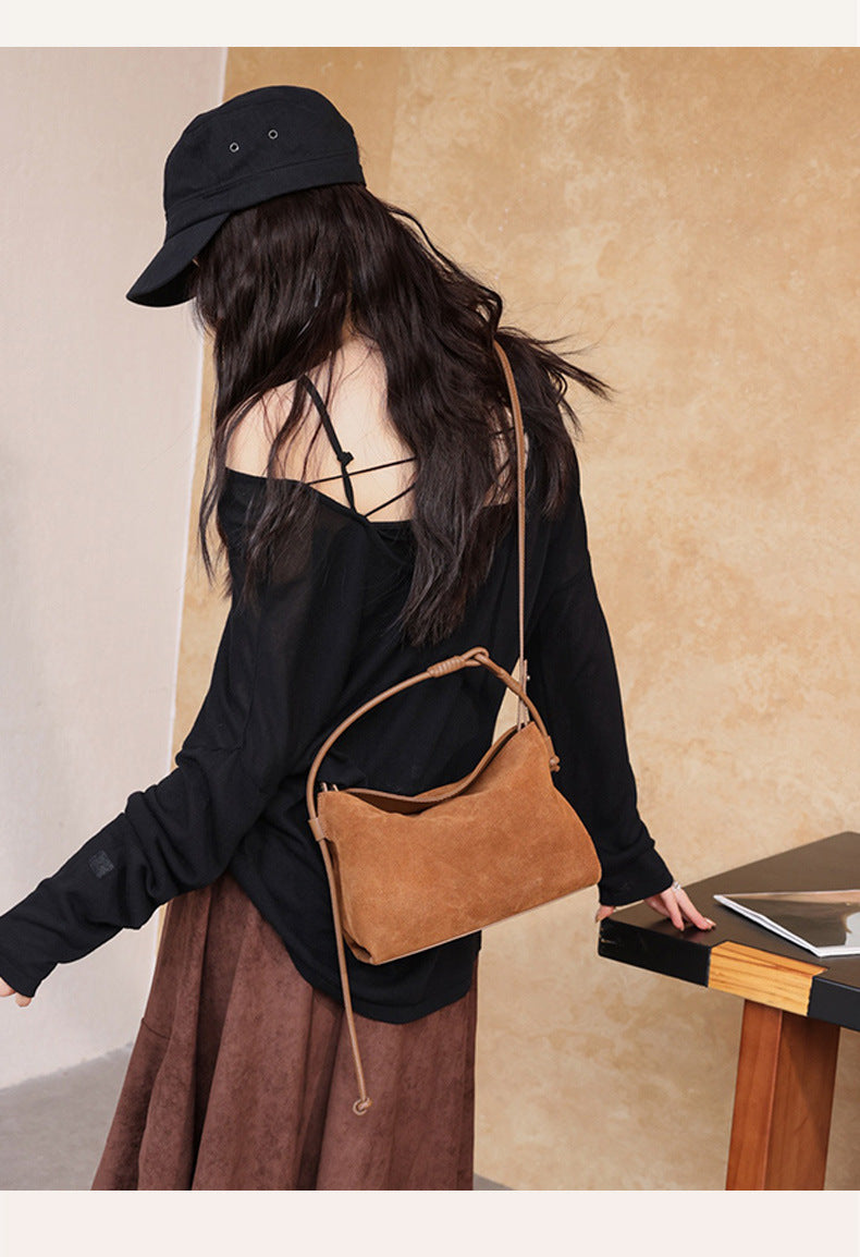 Back view showing the long shoulder strap on the model