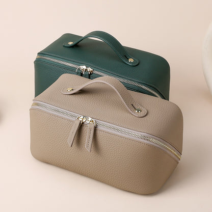 Dark green cosmetic pouch with carry handle and double zipper