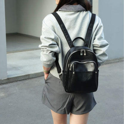Rear view of black leather backpack and shoulder straps