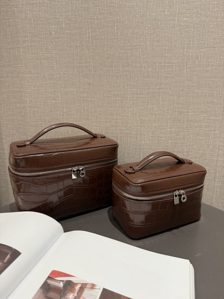 Chocolate cosmetic pouch pair photographed from the front