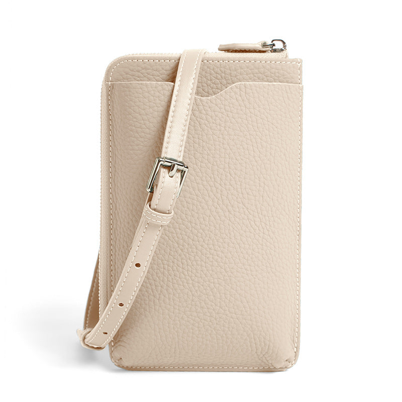 Beige leather phone bag back view showing exterior slip pocket and strap buckle