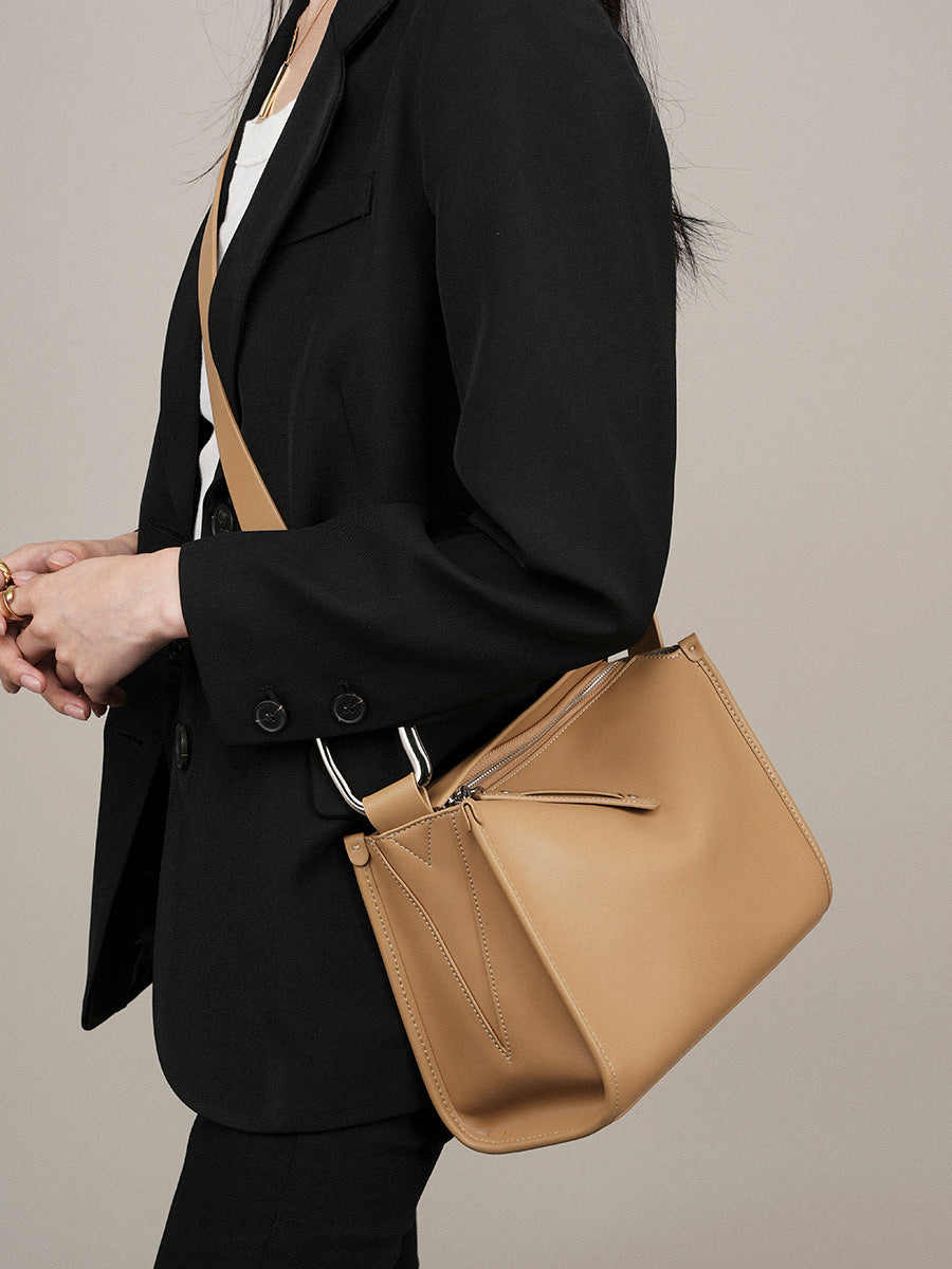 Apricot pillow bag paired with black blazer outfit