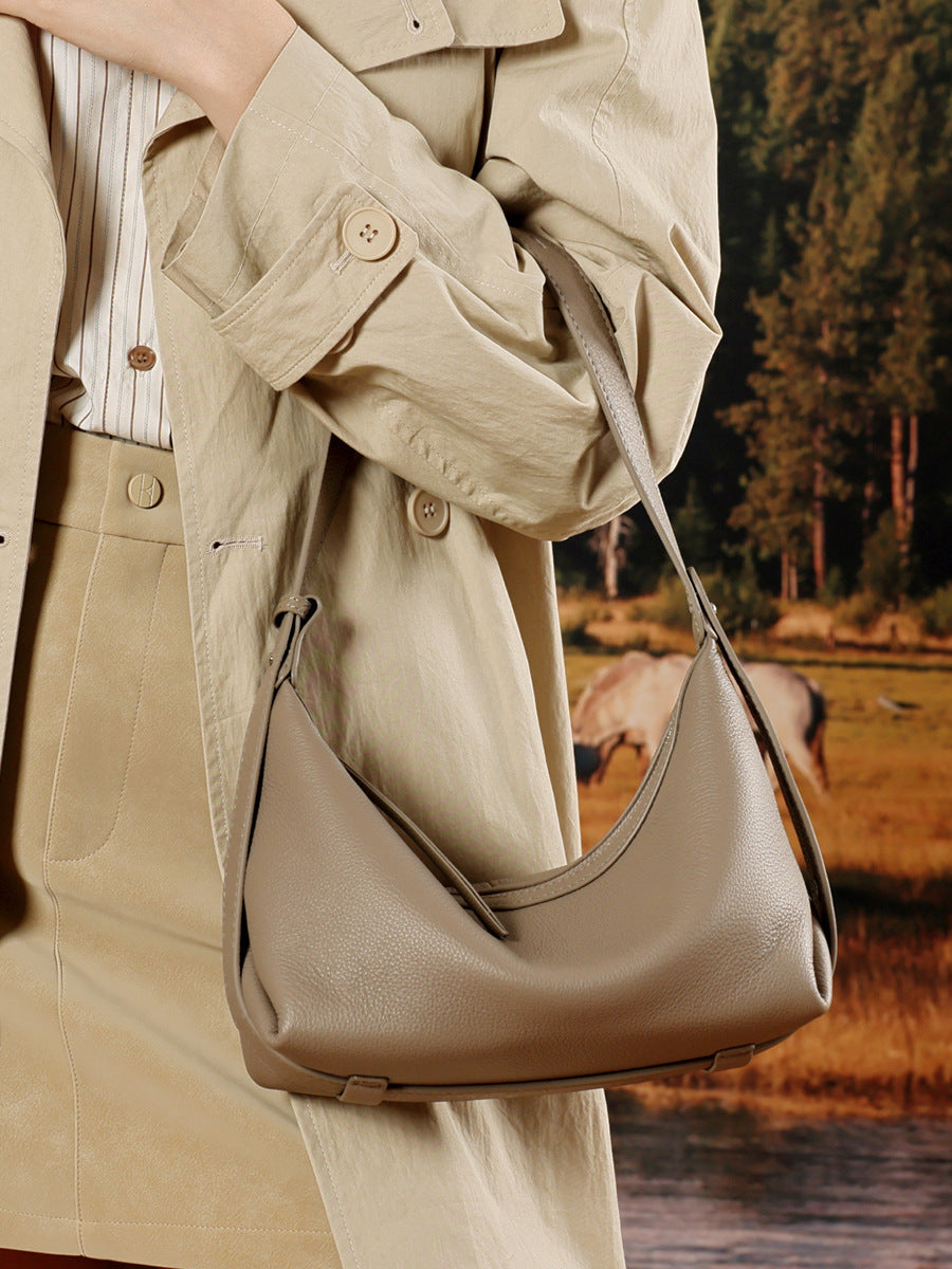 Elephant grey hobo bag styled with trench coat in nature setting