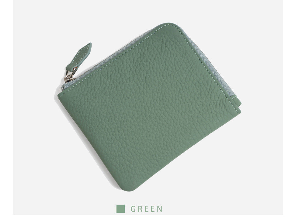 Jade green pebbled leather wallet angled on white background