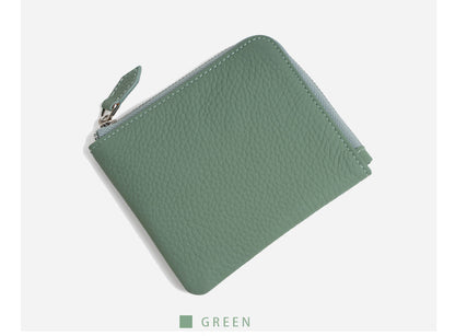 Jade green pebbled leather wallet angled on white background