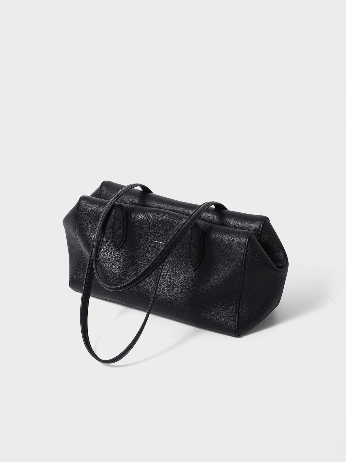 Black tote shown from an angled side view