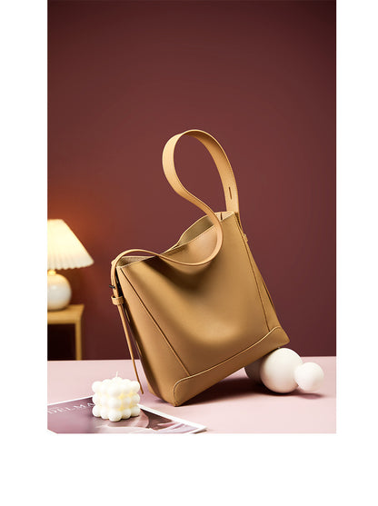Golden Brown bucket bag styled with lamp and book