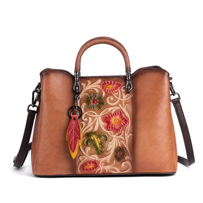 Front view of brown floral cowhide bag with detachable strap