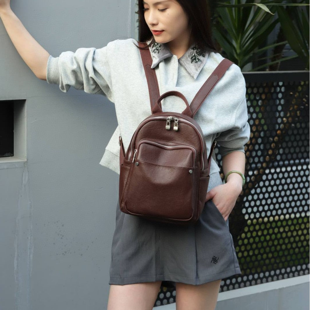 Baroque brown backpack worn on the front with shoulder straps