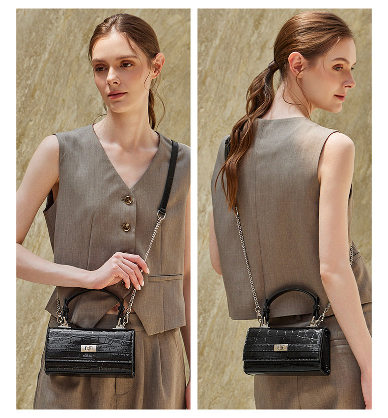 Side-by-side front and back view of model carrying the black croco-embossed crossbody bag