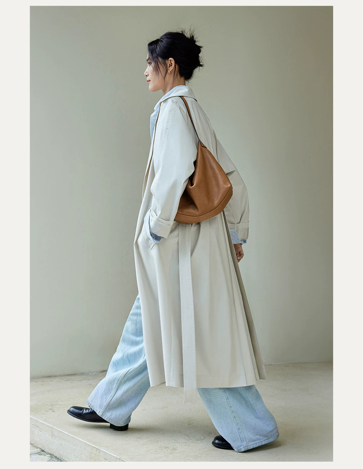 Caramel leather shoulder hobo bag styled with a light coat