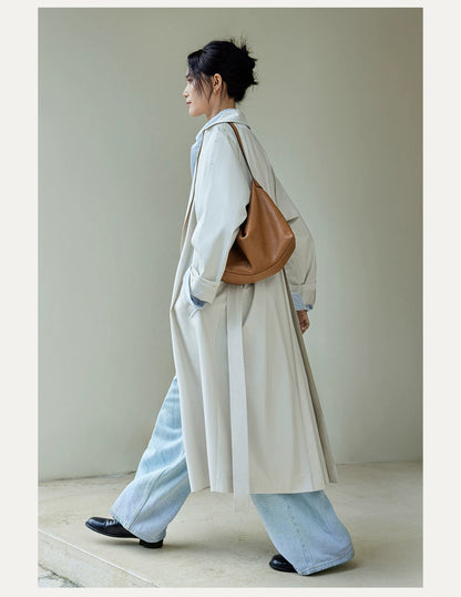 Caramel leather shoulder hobo bag styled with a light coat