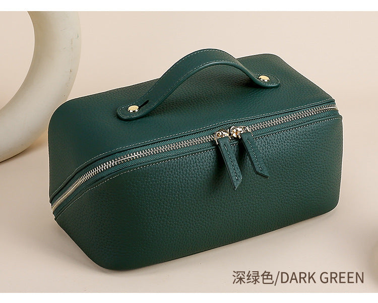 Dark green cowhide toiletry pouch in a front three-quarter view
