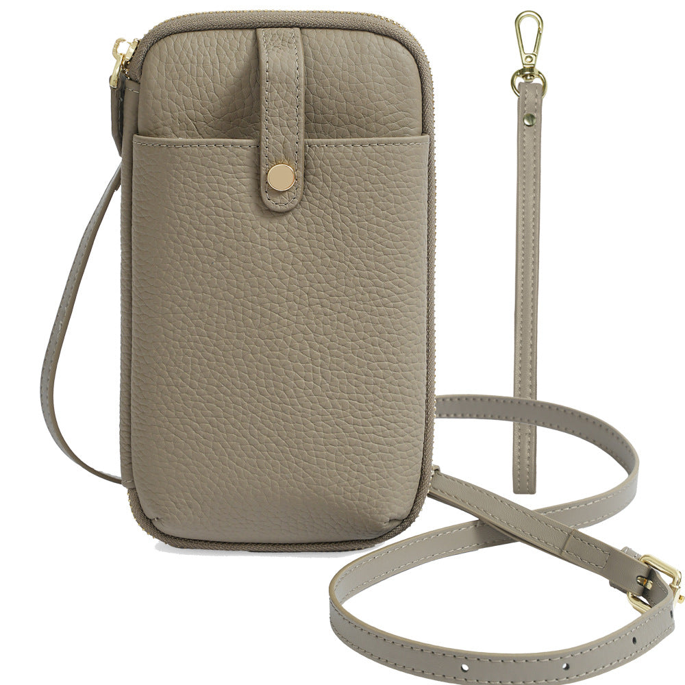 Taupe leather phone bag with detachable wrist strap and crossbody strap shown flat