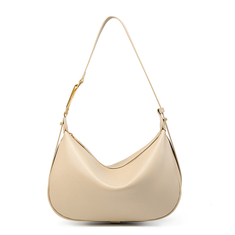 Off-white cowhide crescent underarm bag with gold-tone X buckle on a white background