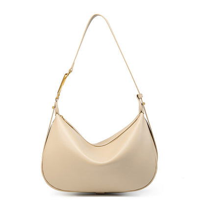 Off-white cowhide crescent underarm bag with gold-tone X buckle on a white background