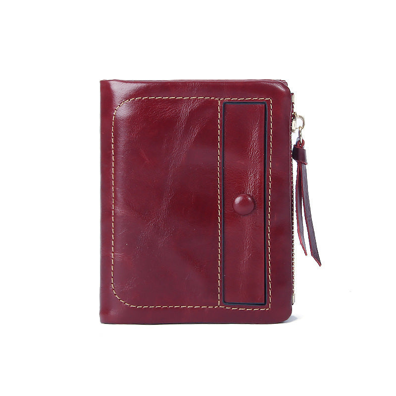 Burgundy top-grain cowhide vintage vertical short wallet showing front with snap flap and leather pull tab