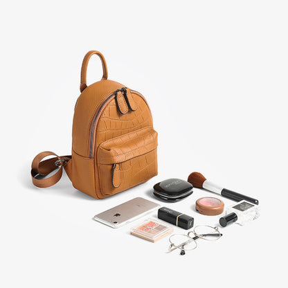 Tan mini backpack with phone and small personal items