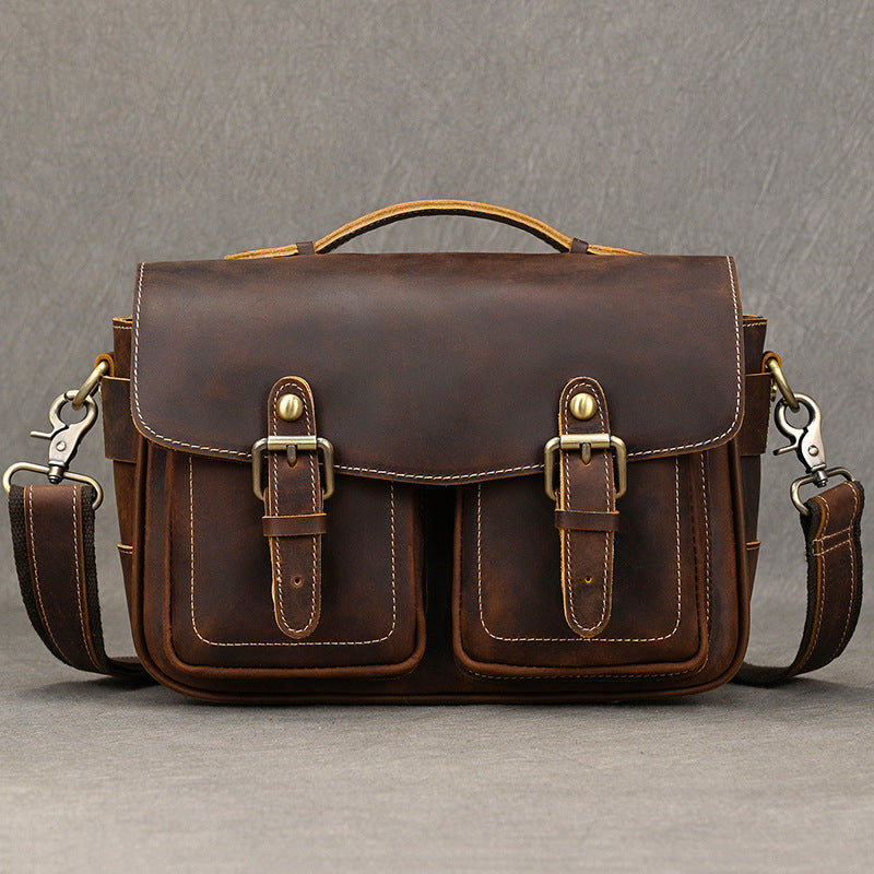Dark brown leather camera bag with shoulder strap attached