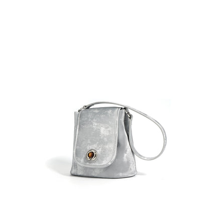 Silver gray split leather bucket bag with strap extended on white background