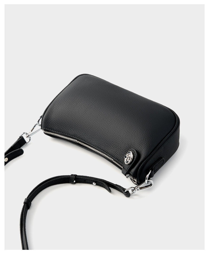 Black version of pebbled leather crossbody bag with strap detail