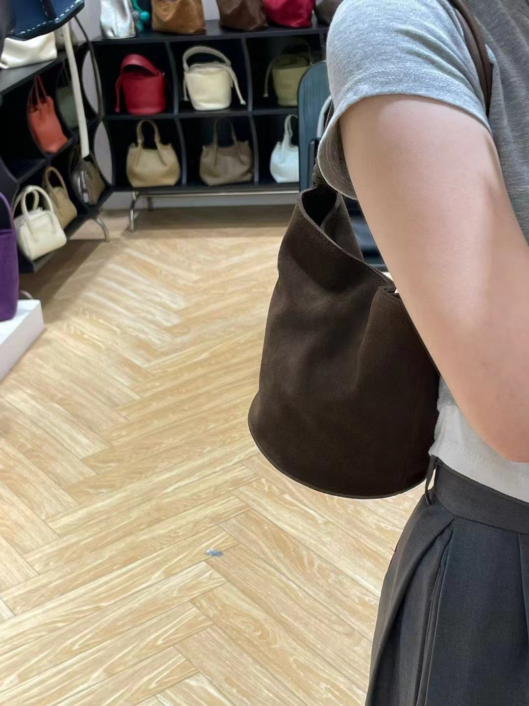 Dark brown bucket bag worn crossbody style
