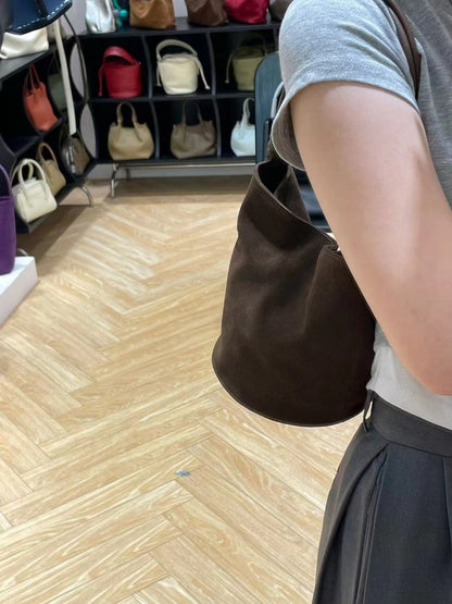 Dark brown bucket bag worn crossbody style