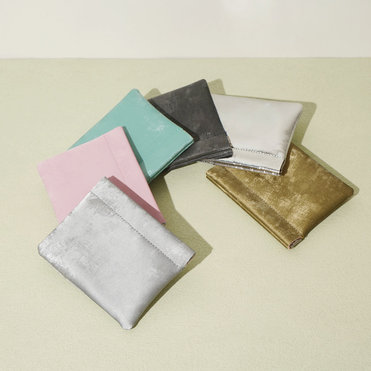 All six colorways of the satin cowhide card pouch laid out together
