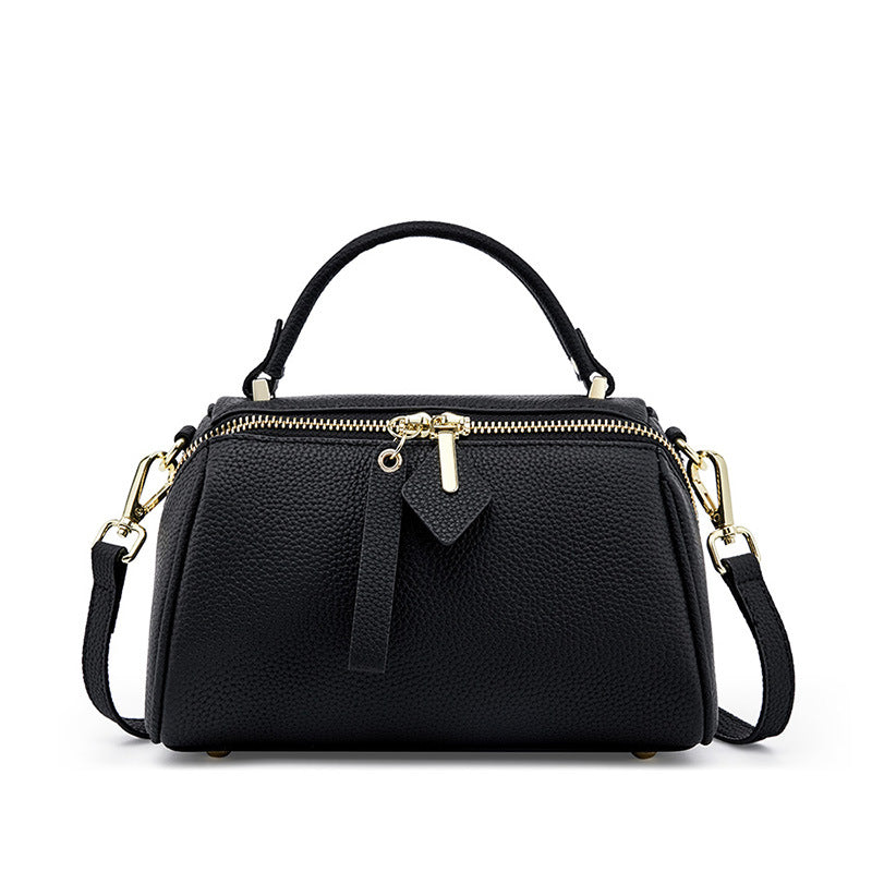Black top-grain cowhide mini Boston bag with gold-tone hardware and dual zip top