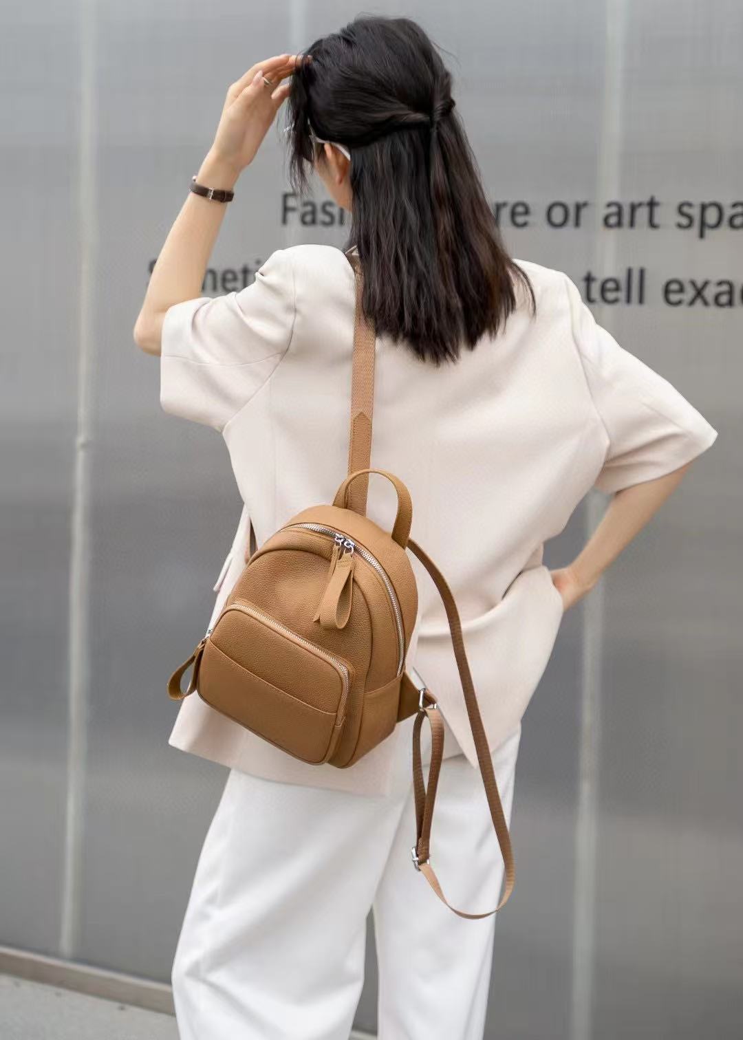 Black leather mini backpack worn from the front