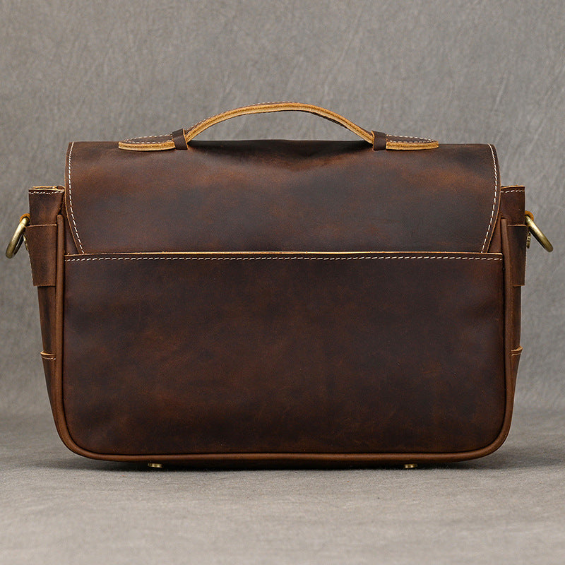 Back panel of dark brown leather camera bag