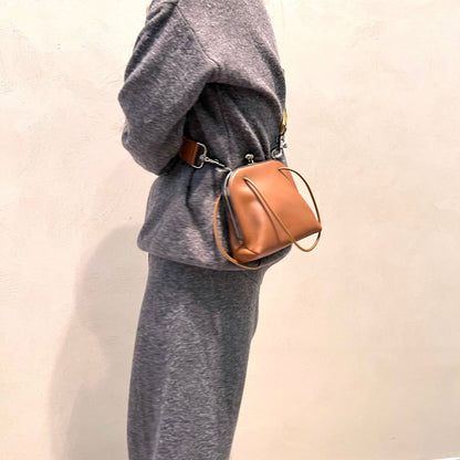 Coffee shoulder bag shown from the side while being carried