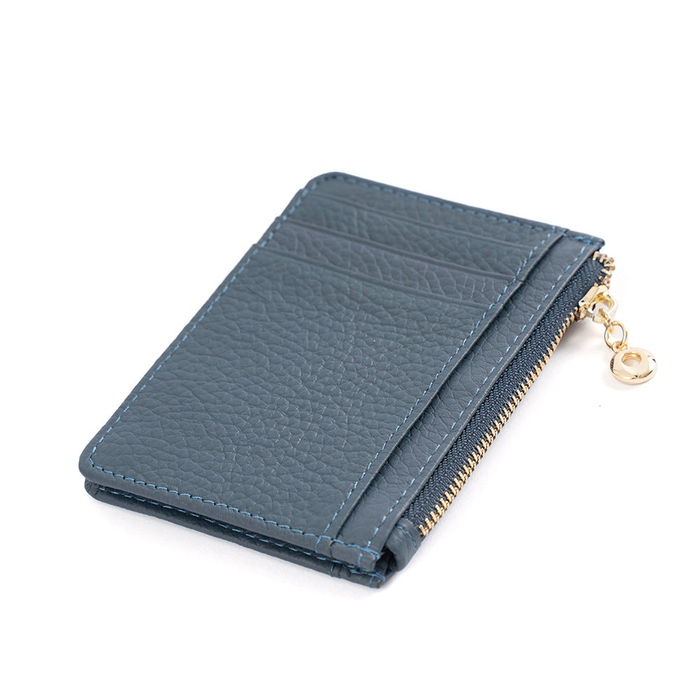 Dark gray slim card holder with gold-tone zipper pull